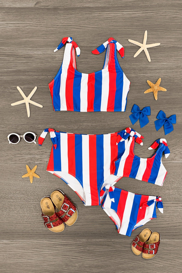 Mom & Me - Red White & Blue Striped Bikini - CHILD-3XS-6-12 Months - Red, white, and blue striped bikini set with tie straps, paired with matching children's swimsuits and sandals.