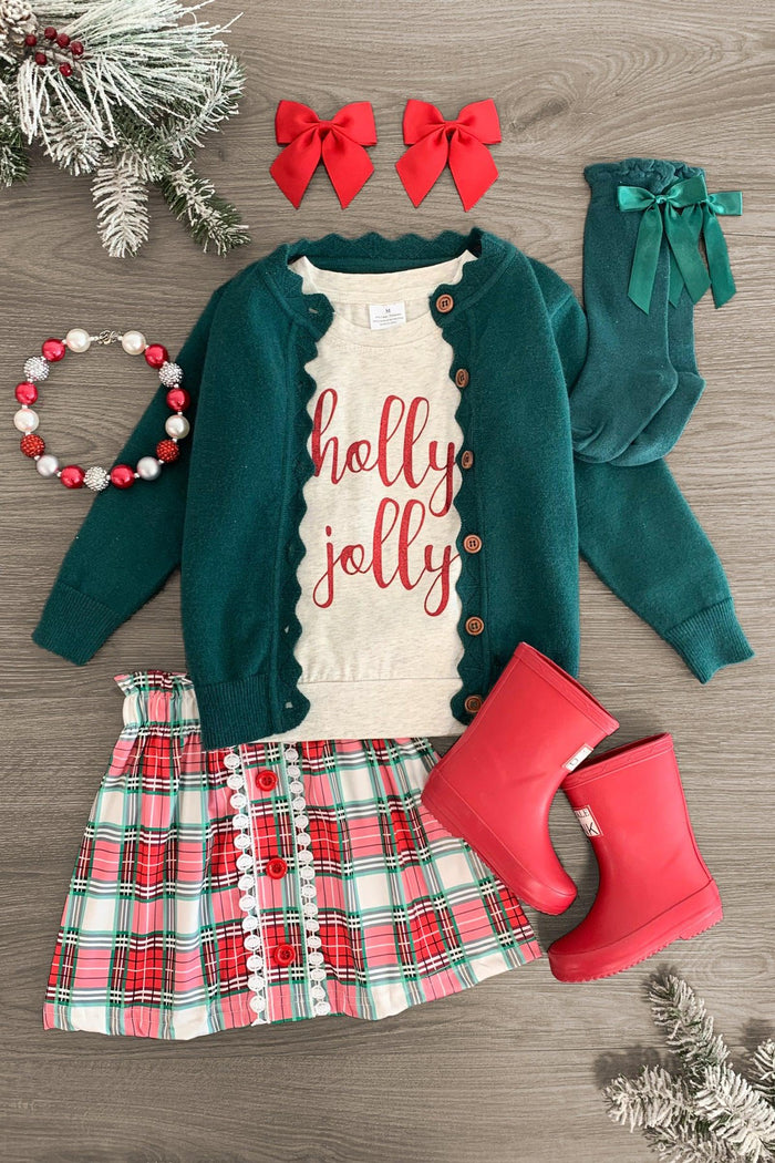 "Holly Jolly" Green Sweater Skirt Set - 3XS-6-12 Months - Toddler green cardigan, cream ruffled top with "holly jolly" red script, plaid skirt, red boots, red bows, and green tights.