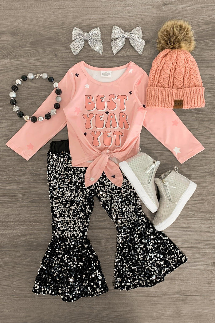 "Best Year Yet" Pink & Black Sequin Bell Bottom Set - 3XS-6-12 Months - Pink long-sleeve shirt with "Best Year Yet" text, black and silver sequin bell-bottom pants, white boots, pink knit hat with .