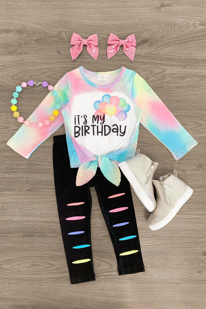 "It's My Birthday" Pastel Rainbow Pant Set - 3XS-6-12 Months - Pastel rainbow tie-dye long-sleeve top with "It's My Birthday" text, black leggings with colorful slits, pink bows, white.