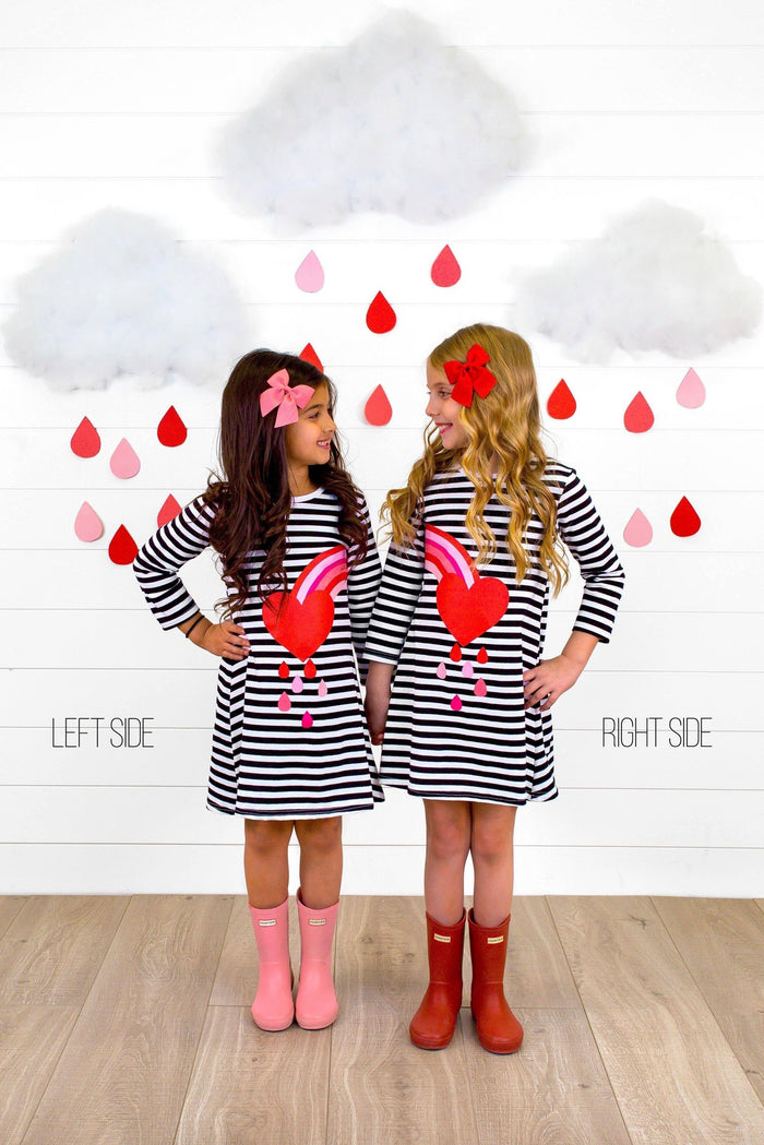 Best Friends Heart Rainbow Stripe Dress - Left Side / 3XS-6-12 Months - Black and white striped dress with red heart and rainbow stripe detail, worn with pink and brown boots on girls.
