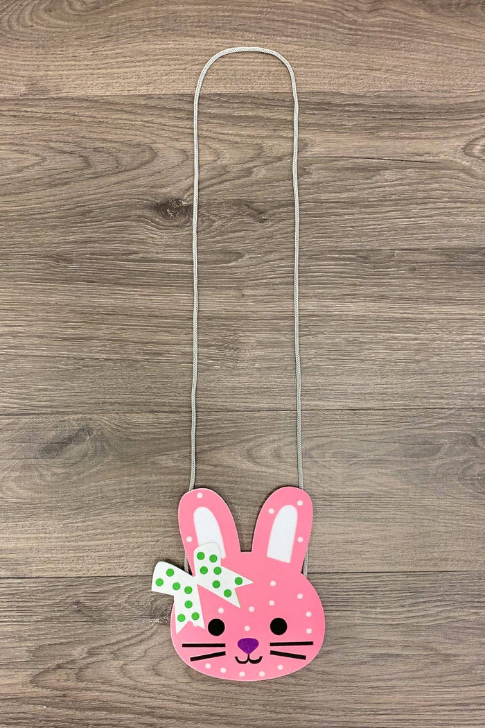 Brinlee Bunny Purse - Default Title - Pink bunny-shaped purse with white polka dots, green bow, and silver chain strap on wood background.