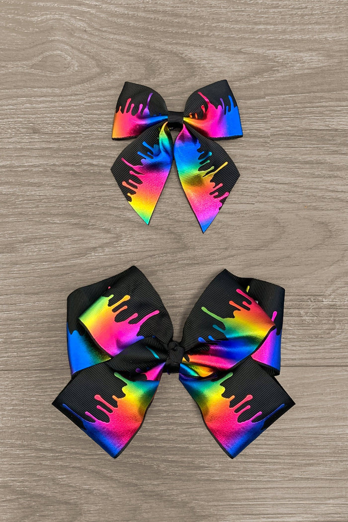 Holographic Melted Crayon Rainbow Bows - 3 inches - Two holographic bows with rainbow melted crayon design on black ribbon, sizes 3 and 6 inches.
