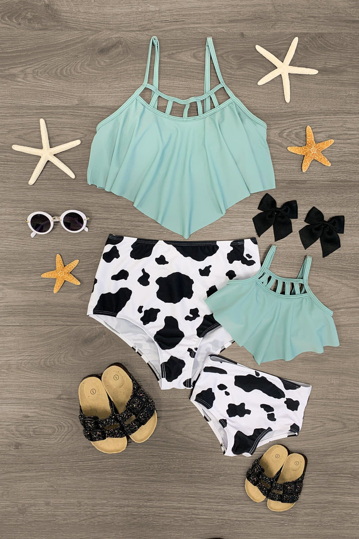 Mom & Me - Sage & Cow Hide Bikini - CHILD-2XS-12-18 Months - Sage green bikini tops with grid straps paired with black and white cow hide print bikini bottoms for mom and child, styled.