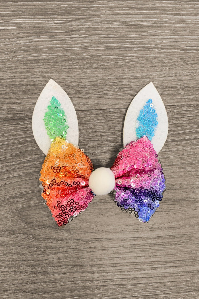 Rainbow Sequin Bunny Bow - Rainbow Sequin Bunny Bow - Rainbow sequin bunny bow with white felt ears and colorful inner ear details on wood background.