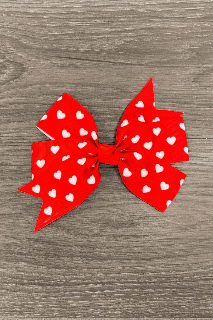 Red & White Heart Bow - Default Title - Red fabric bow with white heart patterns on wooden background.